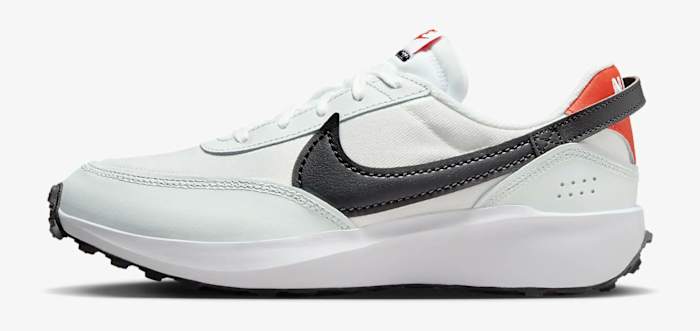 Side view of a white and black Nike running shoe.